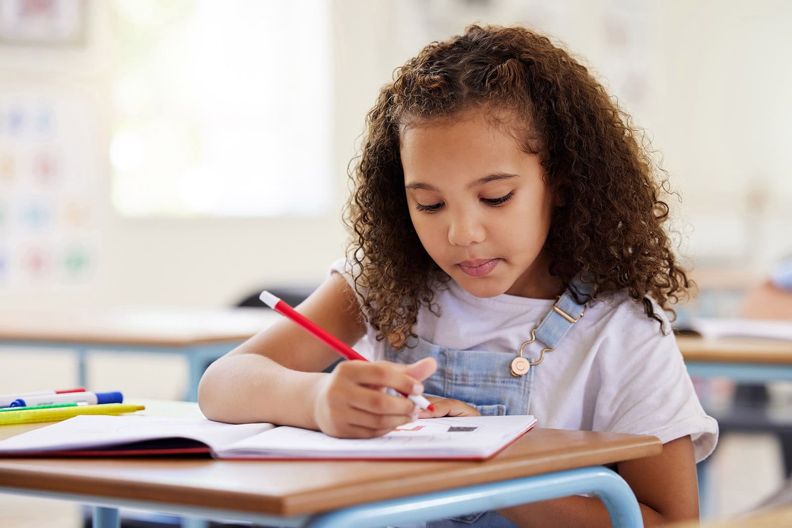 Learning, drawing and girl in classroom for education, exam or studying with book. Preschool, creativity development and serious kid or student coloring for art in notebook in kindergarten or academy, Neuropsychological Evaluations, Wayne, PA